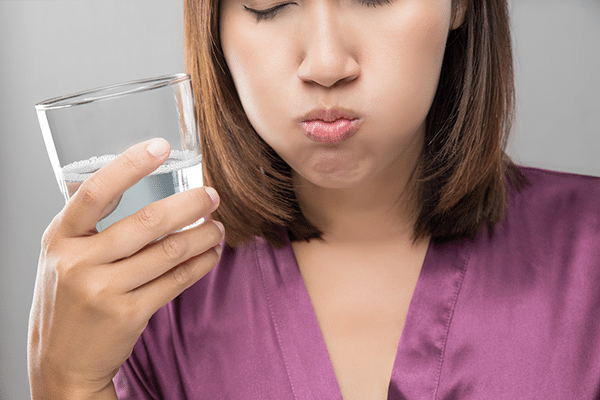 Woman rinsing her mouth