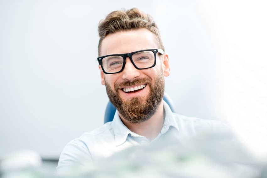 handsome man smiling while having a general dental appointment in Rochester, NY